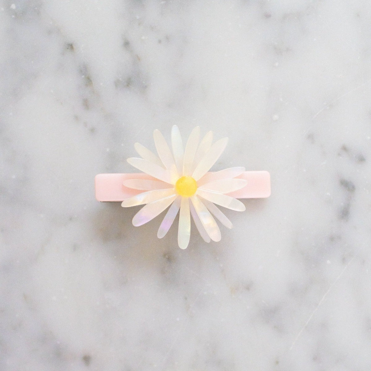 Floral hair clip on a marble background